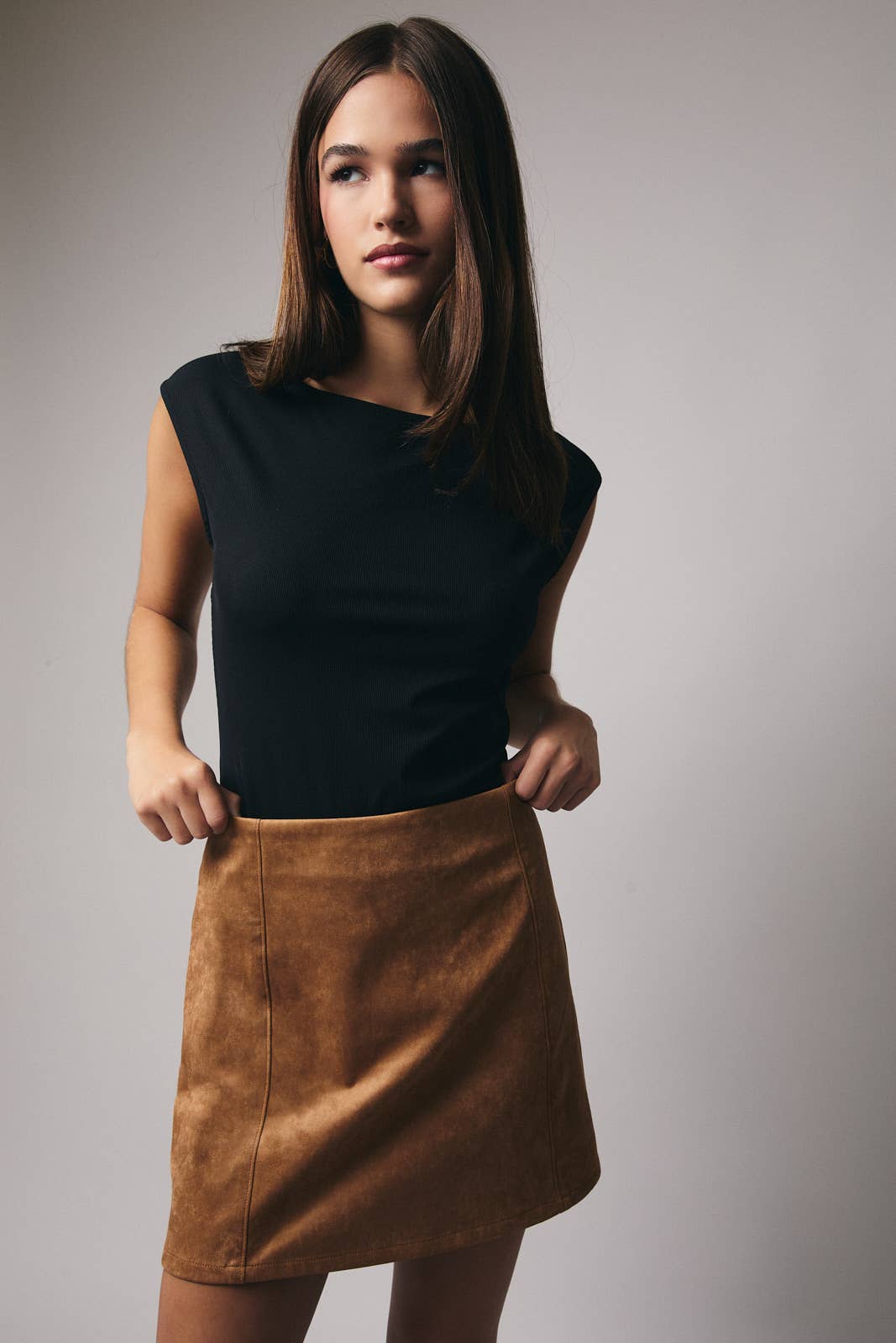 Black Holiday Staple Bodysuit by Sunday Edition by LE LIS, shown on a hanger with smooth fabric and simple design.