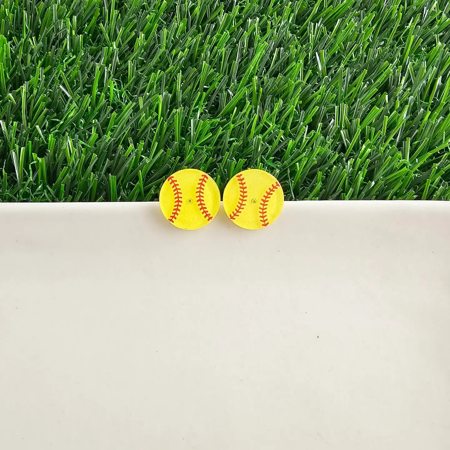 Silver softball glitter studs from Can't Hide Pretty Boutique featuring sparkling glitter and sporty softball design.