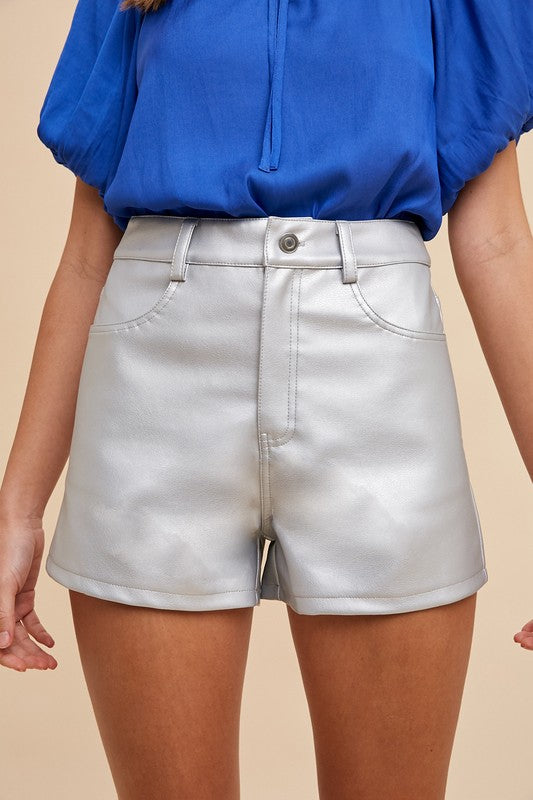 Metallic faux leather shorts from Can't Hide Pretty Boutique, showcasing a shiny, stylish design with a fitted waist and trendy cut.