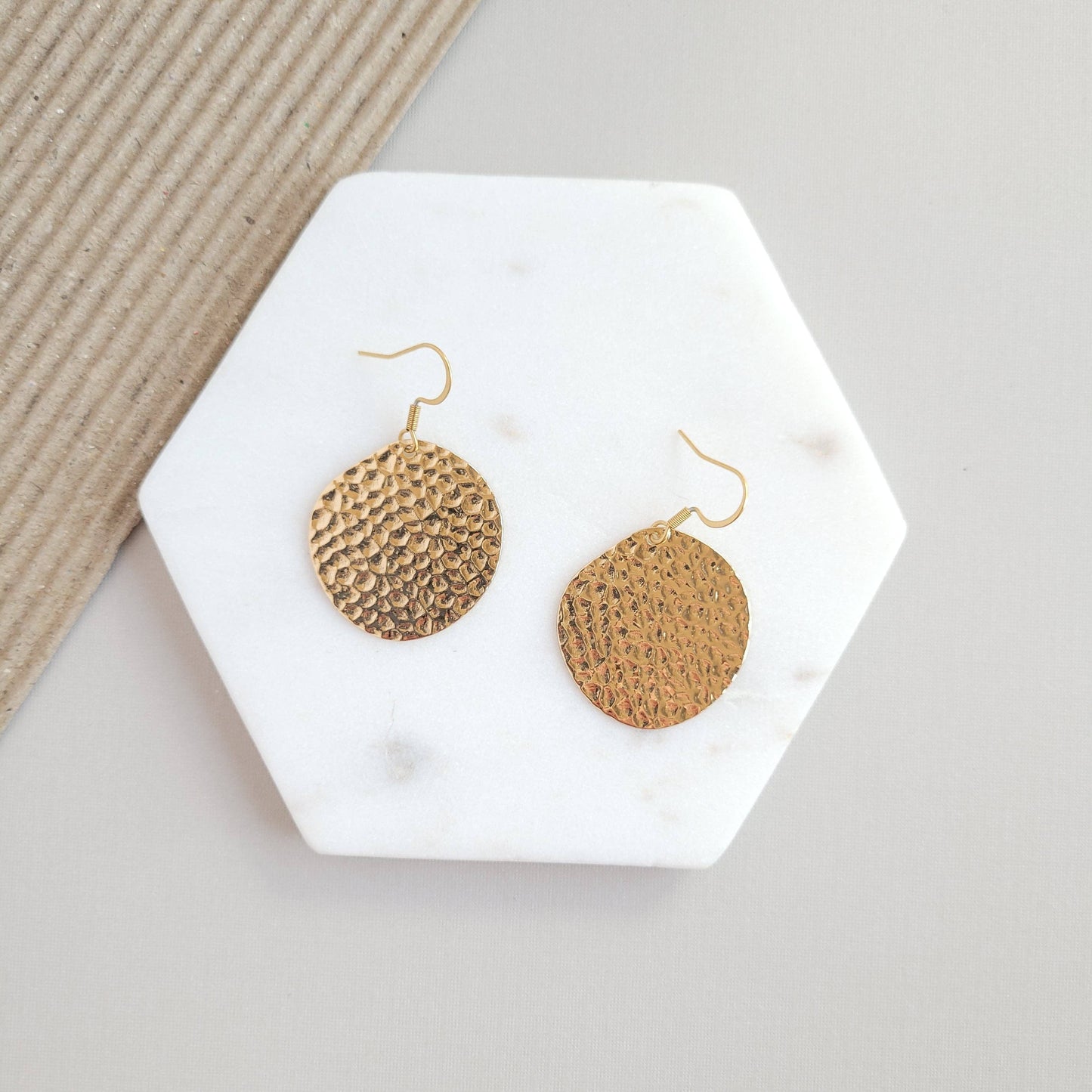 Gold Lucia Earrings by Spiffy & Splendid featuring delicate hoop design with subtle shine on a white background