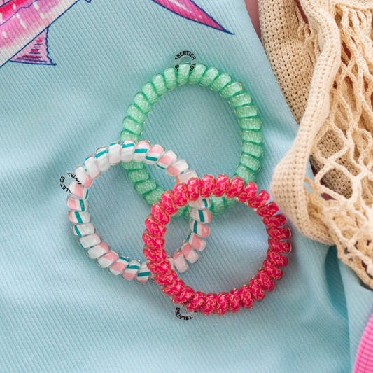 Large TELETIES hair ties featuring a fin-tastic design, shown in a close-up image with vibrant colors on a neutral background.