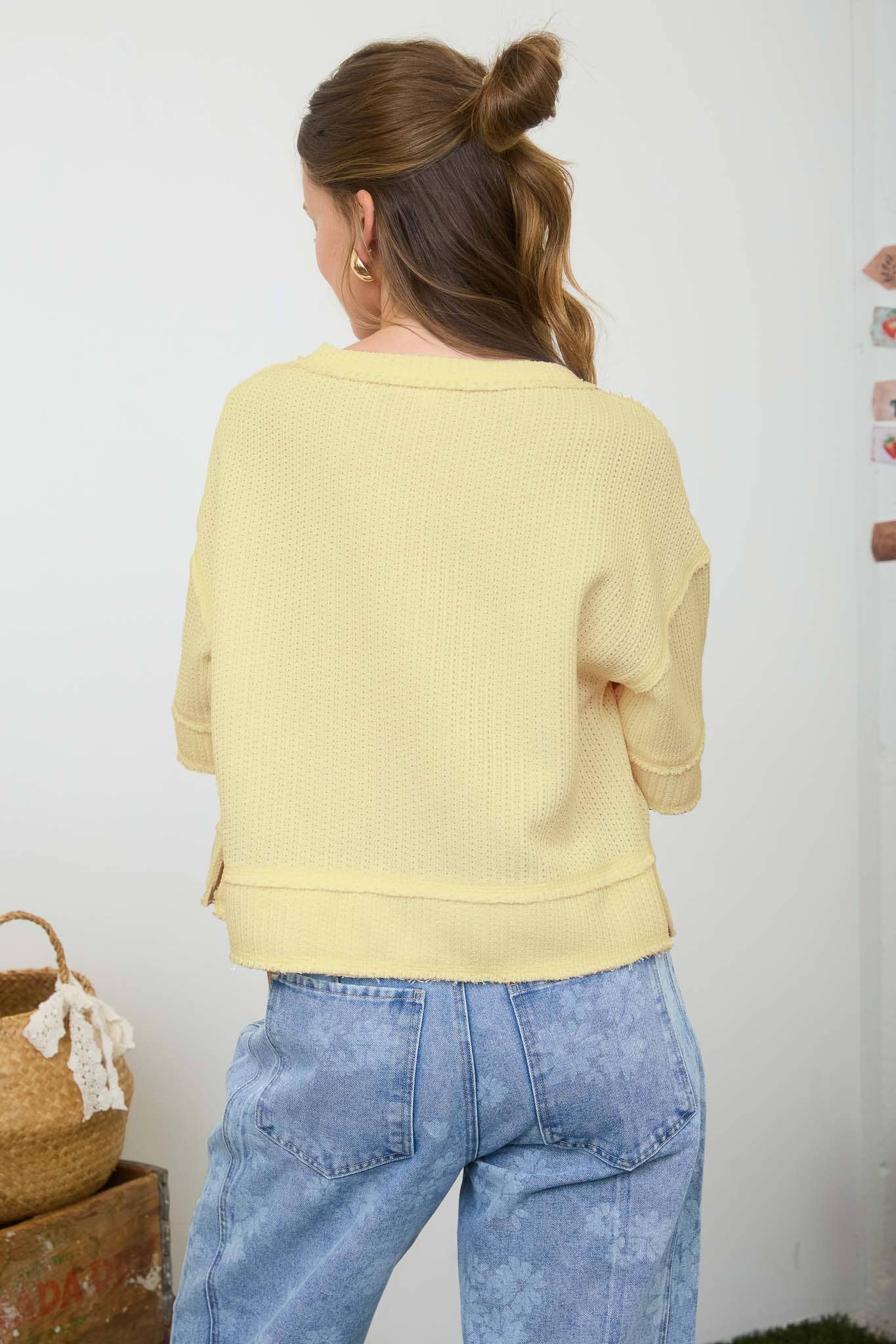 Blu Pepper raw edge henley short sleeve waffle knit top displayed on a hanger with a casual fit and textured fabric.