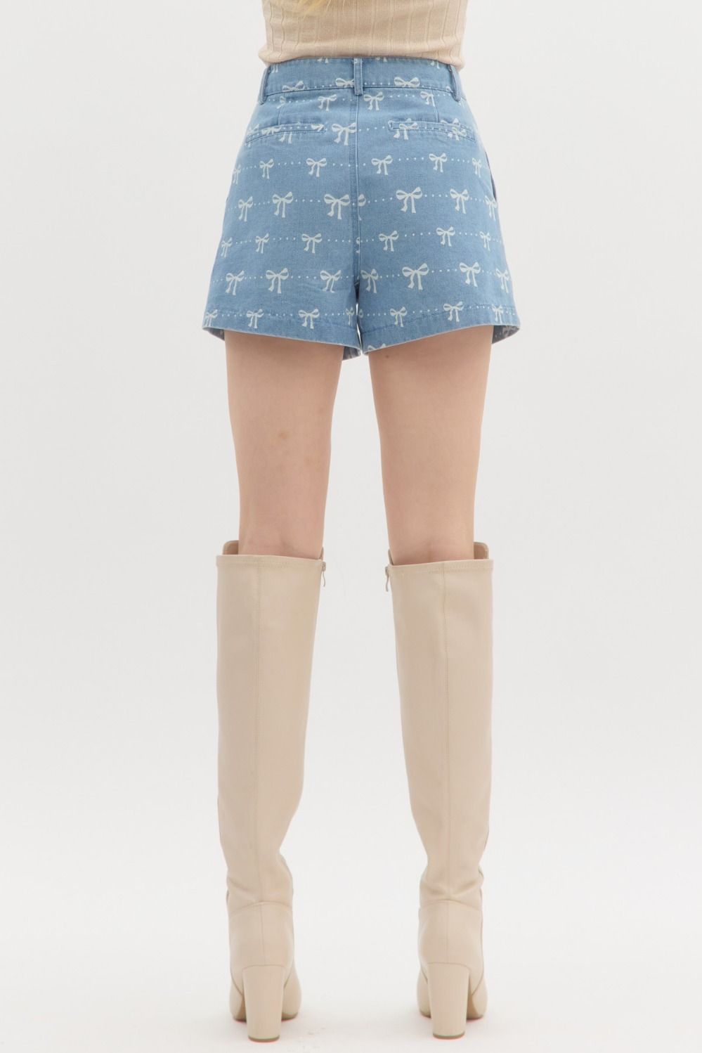 Coquette denim shorts from Can't Hide Pretty Boutique featuring classic blue wash, high waist, and distressed details.