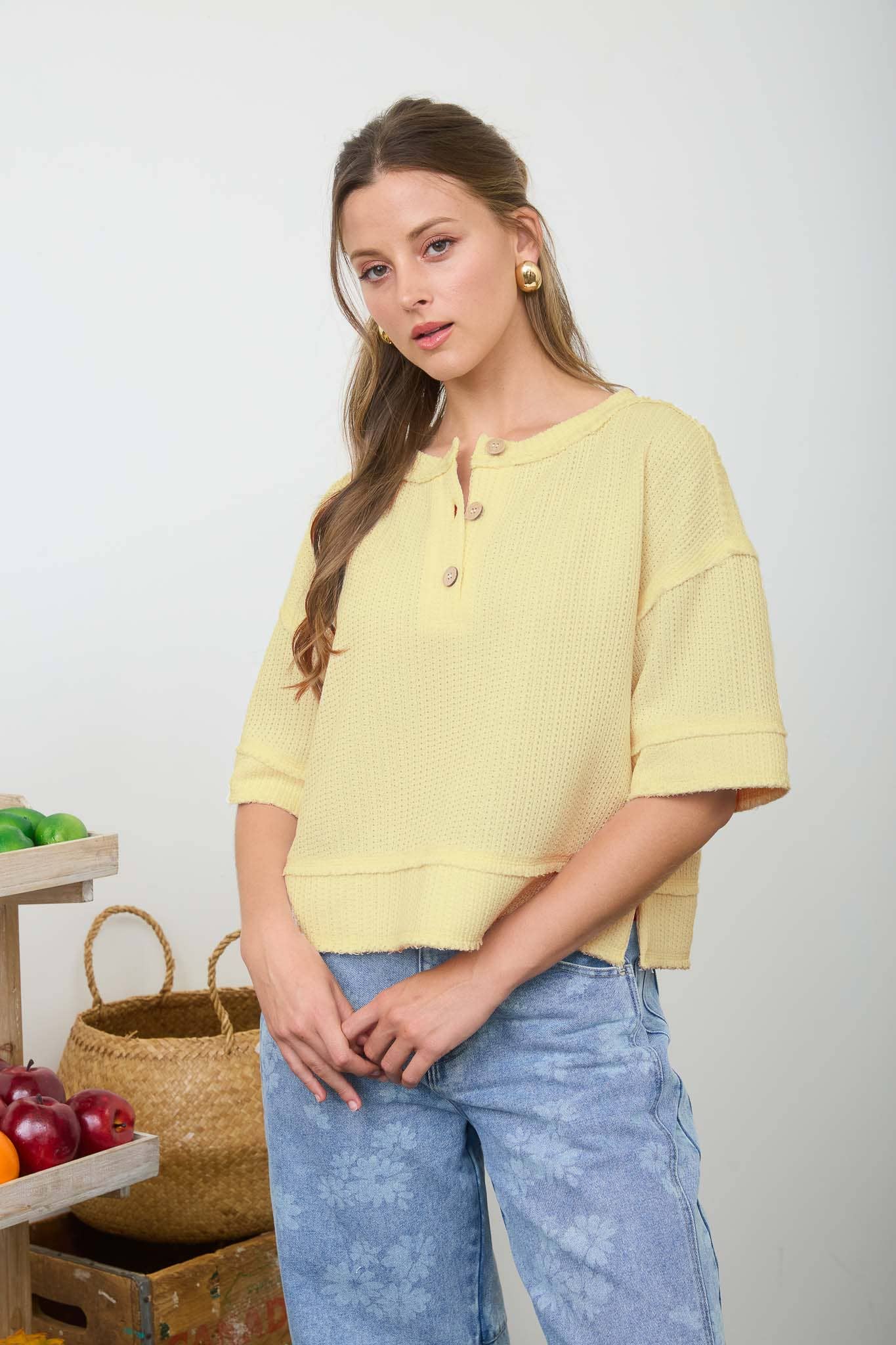 Blu Pepper raw edge henley short sleeve waffle knit top displayed on a model, showcasing its casual fit and textured fabric.